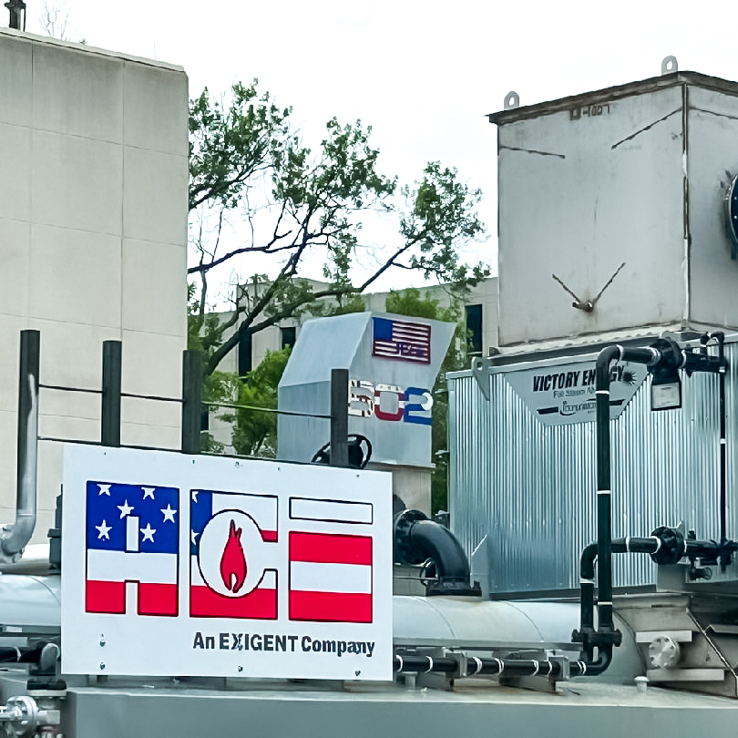 Mechanical equipment at Walter Reed Army Medical Center featuring ACE and Exigent Company branding, with visible ductwork and Victory Energy system components.